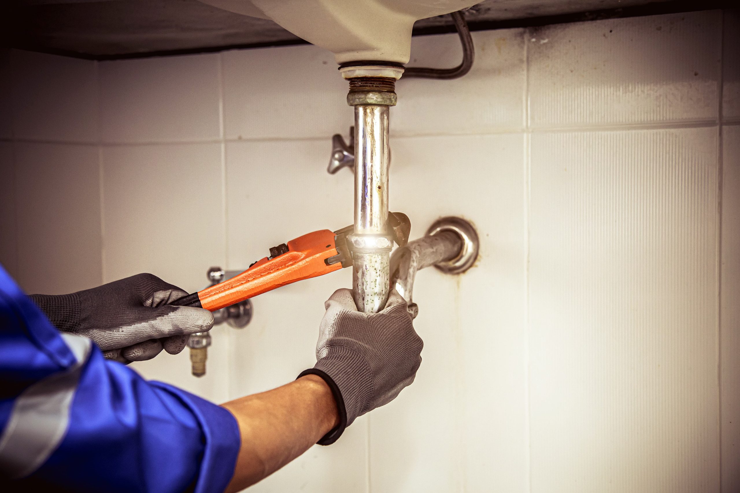 plumber using wrench repair water pipe sink ()